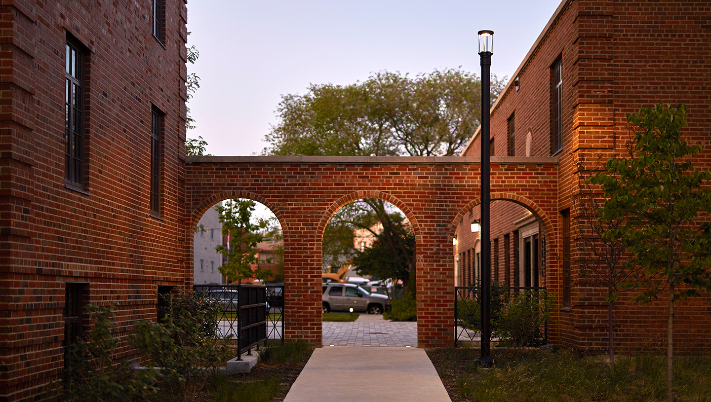 Eclipse fixture illuminates walkway at dusk