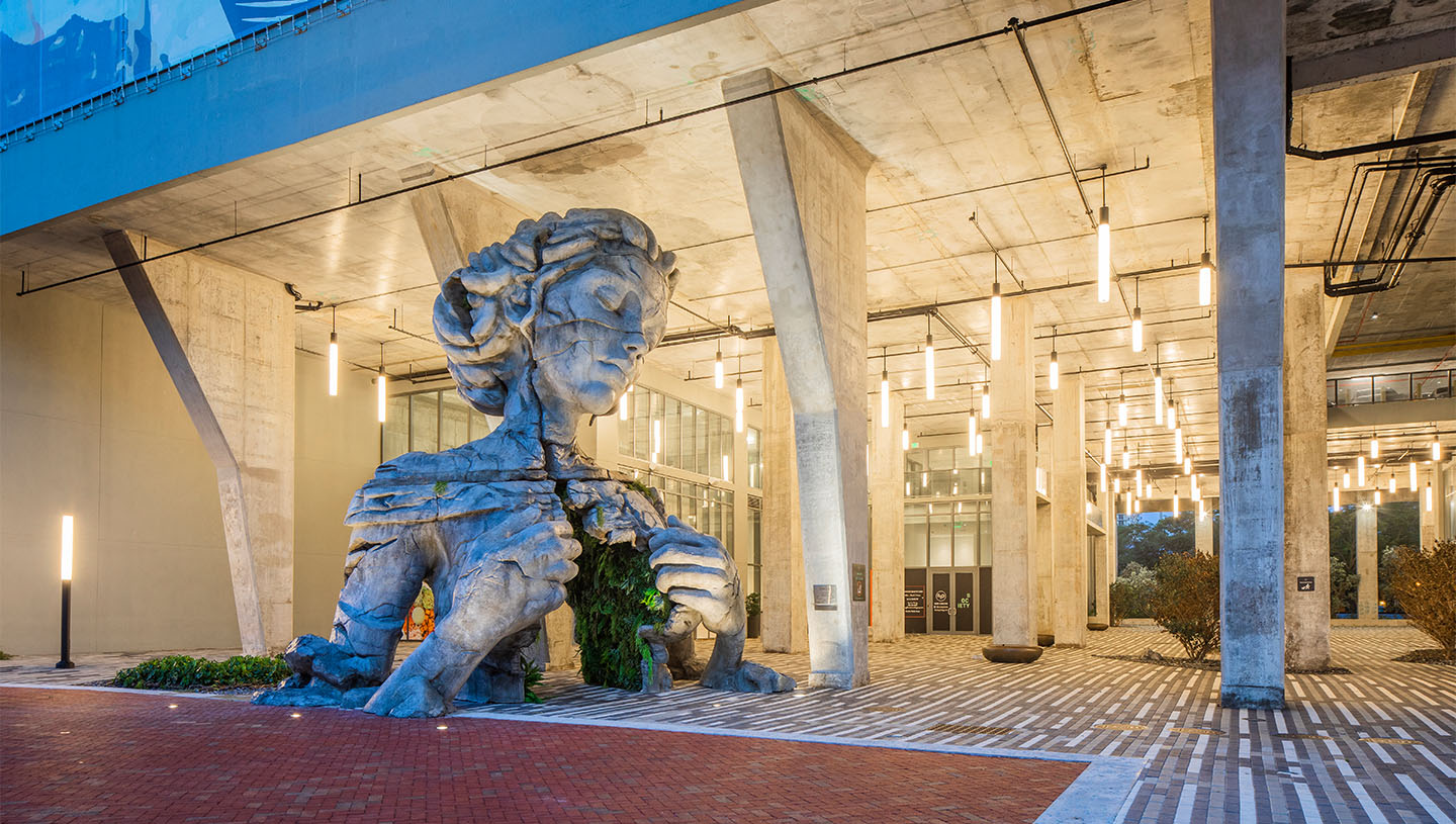 Lumistik illuminates entrance of apartment complex with large stone statue