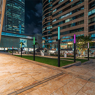 RGBW column lighting by Lumiquad illuminates plaza at night