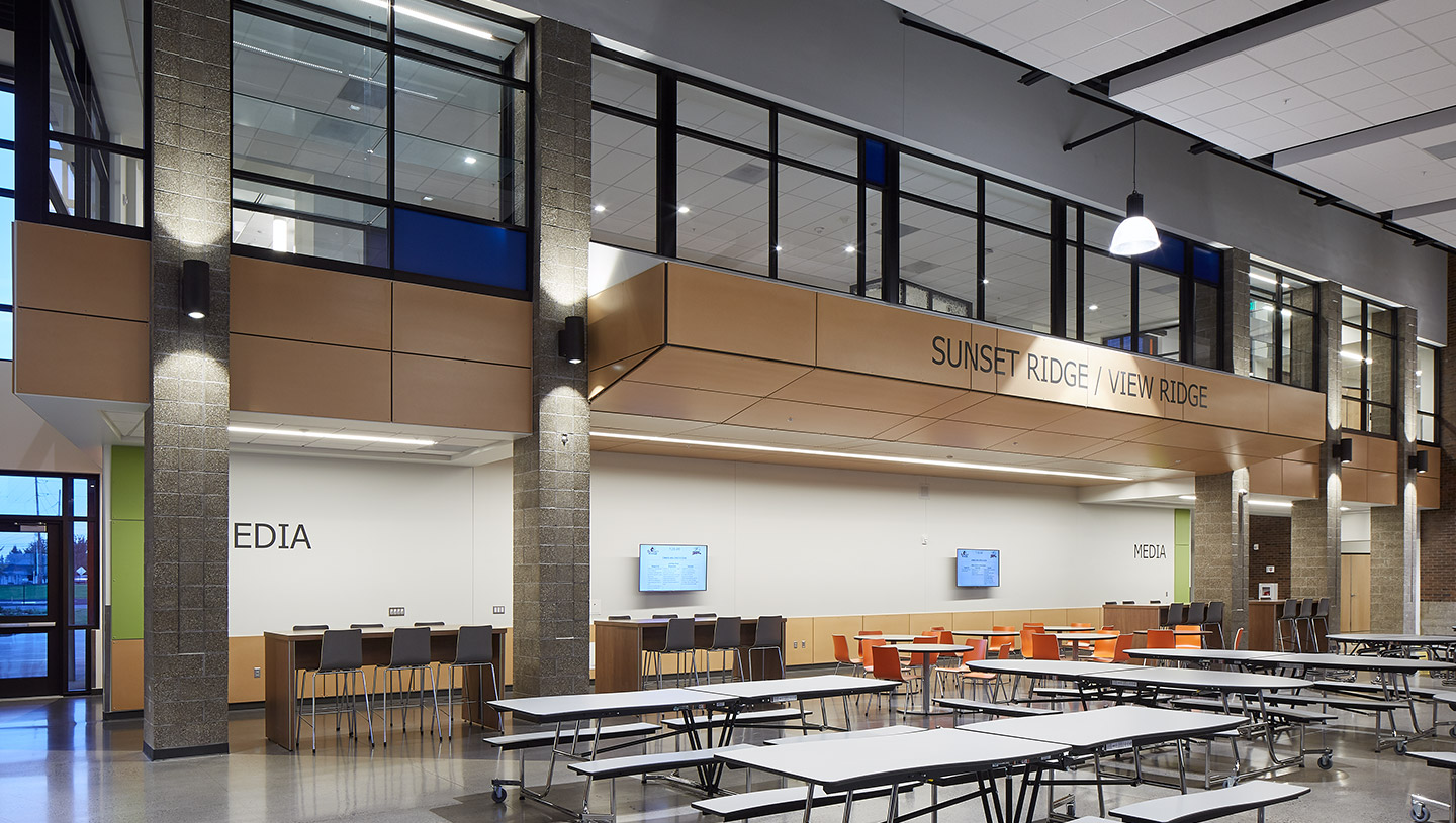 Interior wall mounted cylinders light school cafeteria